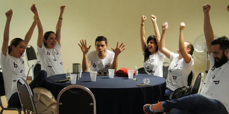 Dos participantes mostrando alegría y creatividad durante una dinámica grupal del rally empresarial
